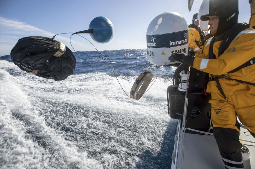 In this March 21, 2018 photo provided by Volvo Ocean Race, Frederico de Melo deploys a scientific drifter to test the water for evidence of pollution in the Pacific Ocean from aboard the vessel "Turn the Tide on Plastic," during the race leg from New Zealand to Brazil. For the sailors, teams, organizers and sponsors, the Volvo Ocean Race is part of a larger race against time, a mission to curb the use of products that litter the ocean and befoul the air. (Sam Greenfield/Volvo Ocean Race via AP)