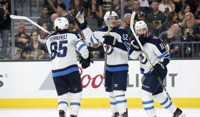 Winnipeg Jets&#x27; Mathieu Perreault, Jack Roslovic and Bryan Little, from left, celebrate after defenseman Tyler Myers&#x27;s goal against the Vegas Golden Knights during the third period of Game 4 of the NHL Western Conference finals hockey playoff series Friday, May 18, 2018, in Las Vegas. (AP Photo/John Locher)