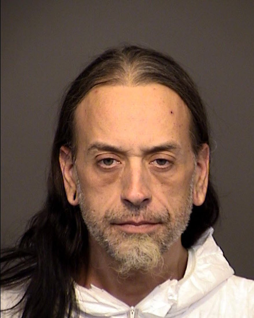 This booking photo released by the Mesa Police Department shows suspect Jesse Dakins, 42. Police say they have arrested Dakins, and Tiffany Warren on suspicion in the death of a missing man with a diminished mental capacity. The Mesa Police Department said Friday, May 18, 2018, officers found a body believed to belong to the man after the pair was arrested and they talked about the man's killing. (Mesa Police Department via AP)