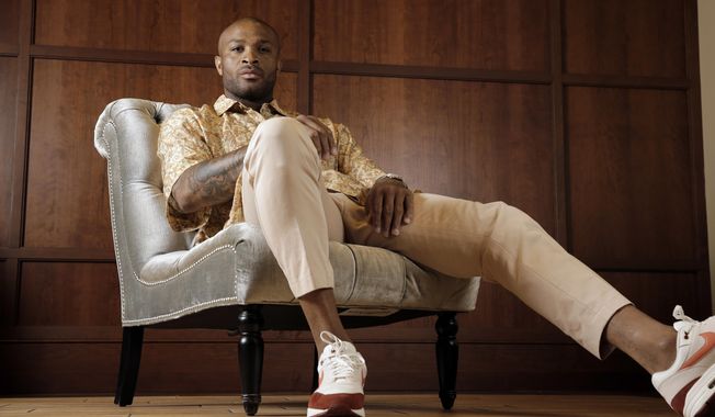 Houston Rockets&#x27; P.J. Tucker poses in a shirt and pants from Dries Van Noten with Nike Air Max 1 shoes Tuesday, May 15, 2018, in Houston. Tucker&#x27;s playing style and defensive grit helped the Houston Rockets to the Western Conference Finals. Off the court Tucker has spent years personally curating a wardrobe that has helped his style ascend to the upper echelons of fashion. (AP Photo/David J. Phillip)