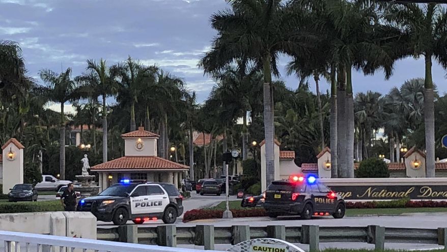 Police respond to The Trump National Doral resort after reports of a shooting inside the resort Friday, May 18, 2018 in Doral, Fla. A man shouting about Donald Trump entered the president's south Florida golf course early Friday, draped a flag over a lobby counter and exchanged fire with police before being arrested, police said. One officer received an unspecified injury, officials said. (AP Photo/Frieda Frisaro)