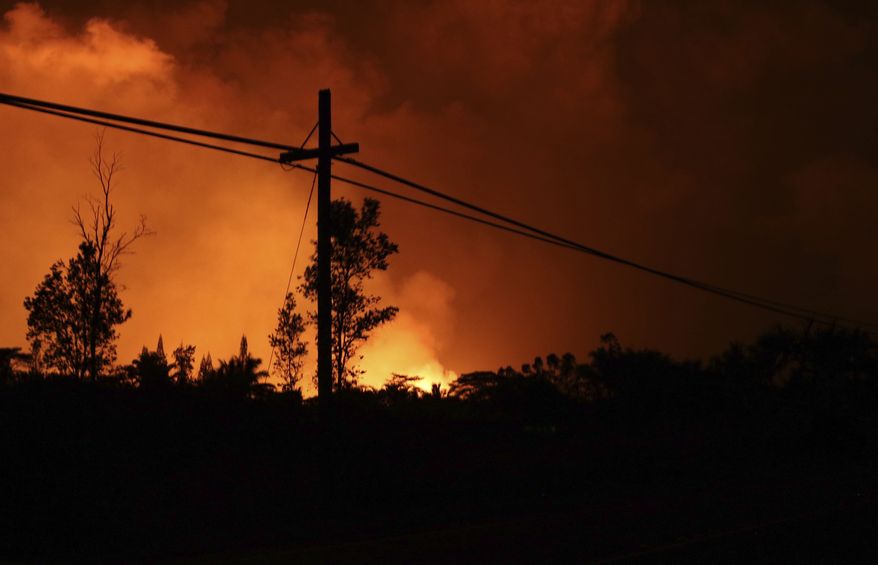 Lava from Kilauea volcano lights up the night sky near Pahoa, Hawaii, Saturday, May 19, 2018. (AP Photo/Caleb Jones)
