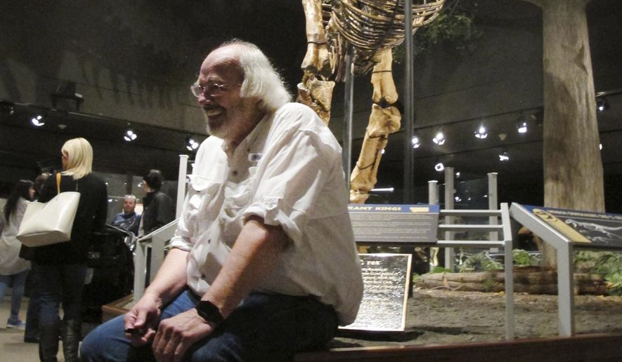 FILE - In this May 21, 2016, file photo, Jack Horner sits under Montana&#x27;s T-Rex in the Museum of the Rockies in Bozeman, Mont. The Montana paleontologist, Horner, who consulted with director Steven Spielberg on the “Jurassic Park” movies is developing a three-dimensional hologram exhibit that will showcase the latest theories on what dinosaurs looked like. Horner and entertainment company Base Hologram are aiming to have multiple traveling exhibits ready to launch in spring 2018. (AP Photo/Matt Volz, File)