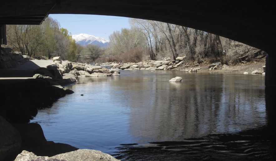 In this April 25, 2018 photo, the Arkansas River flows under a bridge in Salida, Colo., with the snow-covered Sawatch Range mountains in the background. Despite a severe drought across the Southwestern United States, there should be plenty of water this year for rafters and anglers in the Arkansas, one of the nation&#x27;s most popular mountain rivers. State and federal officials say water from melting snow will surge down the river thanks to a surprisingly wet winter in the towering peaks of the Sawatch Range where the river begins. (AP Photo/Dan Elliott)