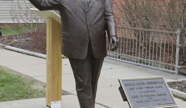 In a photo from, Friday, April 27, 2018, a statue of former Mayor Orville Hubbard, who spent decades trying to keep the city all white, is displayed in Dearborn, Mich. The statue was socked away for more than a year after leaders decided it didn&#x27;t belong outside a new City Hall. Vestiges of racism and intolerance are slowly being moved and removed in Michigan and other northern states as calls continue in the South to take down such monuments. (AP Photo/Carlos Osorio)