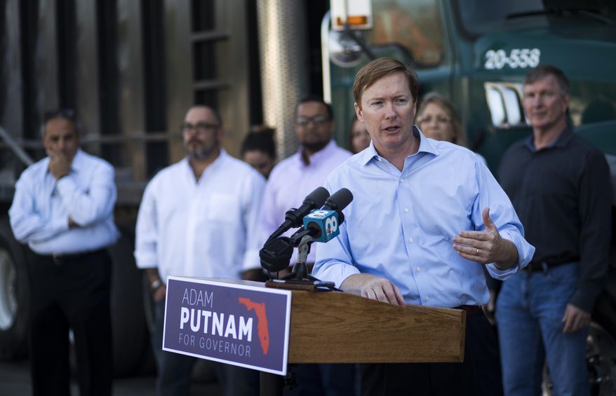 FILE - In this April 6, 2018, file photo, Adam Putnam, Republican gubernatorial candidate makes a campaign stop at Kimmins Contracting in Tampa, Fla. Florida’s wide-open race for governor won’t be decided for another six months, but it’s already triggered a wave of expensive television ad buys from groups taking advantage of gray areas in the state’s campaign finance laws. Florida Grown, a political committee linked to Putnam, has raised millions, much of it coming from large donations from companies such as Publix, Florida Power & Light and Disney. (Monica Herndon/Tampa Bay Times via AP, File)