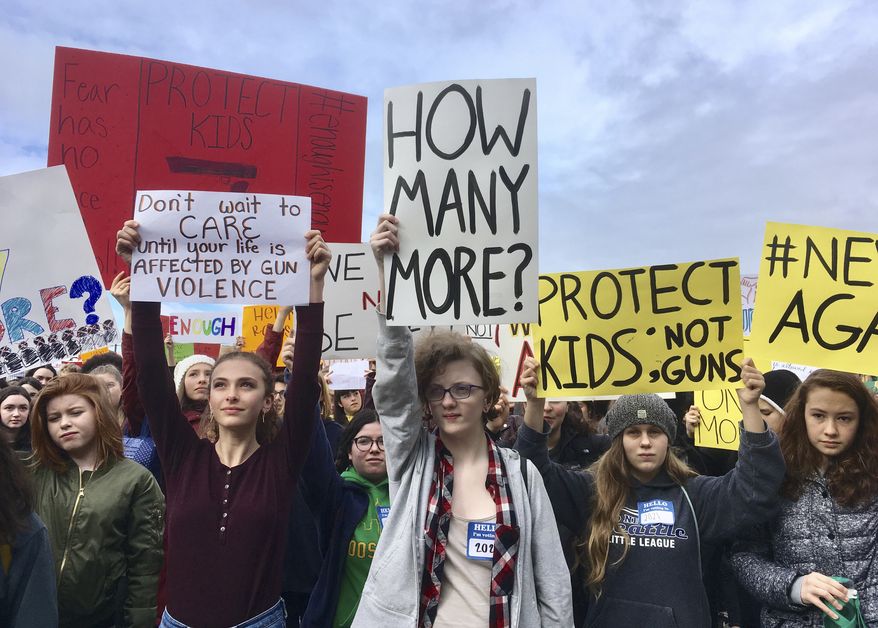 Students at Roosevelt High School take part in a protest against gun violence Wednesday, March 14, 2018, in Seattle. Politicians in Washington state are joining students who walked out of class to protest against gun violence. It was part of a nationwide school walkout that calls for stricter gun laws following the massacre of 17 people at a Florida high school. (AP Photo/Manuel Valdes)