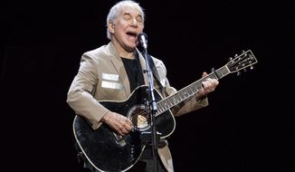 In this May 16, 2018, file photo, Paul Simon kicks off his &quot;Homeward Bound: The Farewell Tour&quot; in Vancouver, British Columbia. Simon, who&#39;s 76, isn&#39;t retiring. He has a disc due out this fall and promises he&#39;ll still occasionally appear on stage. He’s done with the idea of long concert tours, so if you live in Greensboro, Austin or Orlando and want to see him perform, this is it. (Jimmy Jeong/The Canadian Press via AP)