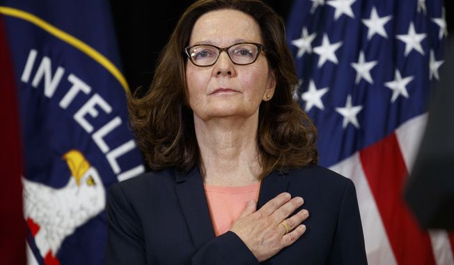 Incoming Central Intelligence Agency director Gina Haspel stands for the national anthem during her swearing-in ceremony at CIA Headquarters, Monday, May 21, 2018, in Langley, Va. (AP Photo/Evan Vucci)
