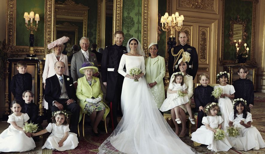 In this photo released by Kensington Palace on Monday May 21, 2018, shows an official wedding photo of Britain's Prince Harry and Meghan Markle, center, in Windsor Castle, Windsor, England, Saturday May 19, 2018. Others in photo from left, back row, Jasper Dyer, Camilla, Duchess of Cornwall, Prince Charles, Doria Ragland, Prince William; center row, Brian Mulroney, Prince Philip, Queen Elizabeth II, Kate, Duchess of Cambridge, Princess Charlotte, Prince George, Rylan Litt, John Mulroney; front row, Ivy Mulroney, Florence van Cutsem, Zalie Warren, Remi Litt. (Alexi Lubomirski/Kensington Palace via AP)