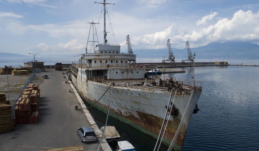 In this Thursday, May 10, 2018 aerial photo, Galeb (Seagull), the yacht once used by the late president of socialist Yugoslavia Josip Broz Tito, is moored in the port of the Adriatic city of Rijeka, Croatia. Decades of rust are covering its hull, the furniture is broken in its once luxurious salons, its powerful engines are permanently idle _ but against all odds, the iconic yacht that once belonged to the late Yugoslav strongman has been given a new lease of life and will be turned into a floating museum. (AP Photo/Darko Bandic)