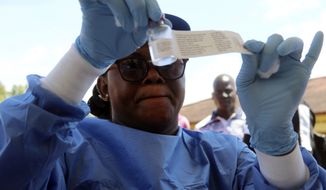 A health worker prepares an Ebola vaccine to administer to health workers during a vaccination campaign in Mbandaka, Congo, Monday, May 21, 2018. Congo&#39;s health minister says a nurse has died from Ebola in Bikoro, the rural northwestern town where the outbreak began, as the country begins a vaccination campaign. (AP Photo/John Bompengo)