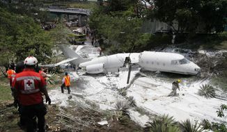 A white Gulfstream jet that appears broken in half near the center, lies engulfed in foam sprayed by firefighters, in Tegucigalpa, Honduras, Tuesday, May 22, 2018. The private jet crashed off the end of the runway at Tegucigalpa&#39;s airport Tuesday, but the crew and passengers were rescued and reportedly out of danger, according to Honduras emergency management agency. (AP Photo/Fernando Antonio)