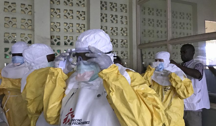 In this photo taken Sunday, May 20, 2018, a team from Medecins Sans Frontieres (Doctors Without Borders) dons protective clothing and equipment as they prepare to treat Ebola patients in an isolation ward of Mbandaka hospital in Congo. Congo&#x27;s health ministry announced Tuesday, May 22, 2018, six new confirmed cases of the Ebola virus and two new suspected cases while a vaccination effort enters its second day. (Louise Annaud/Medecins Sans Frontieres via AP)