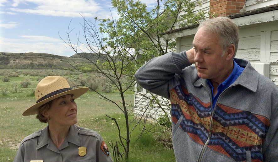 U.S. Interior Secretary Ryan Zinke, right, speaks with Theodore Roosevelt National Park Superintendent Wendy Ross during a visit to the park in western North Dakota on Tuesday, May 22, 2018. Zinke reiterated his support for addressing a maintenance backlog at national parks during a visit to the one named for the U.S. president known for being a champion of conservation. (AP Photo/Blake Nicholson)