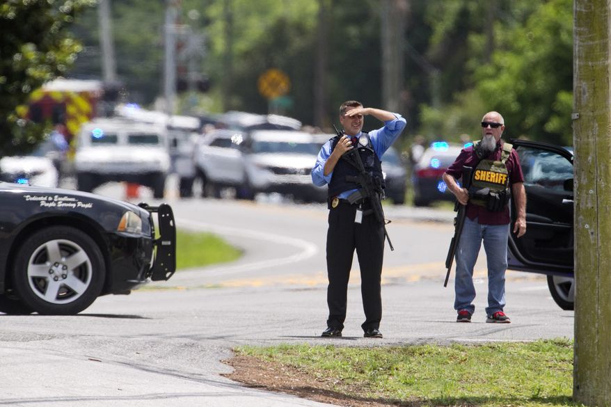 Bay County Sheriff's Office and other law enforcement respond to an active shooter at the corner of 23rd Street and Beck Avenue, Tuesday, May 22, 2018, in Panama City, Fla. (Joshua Boucher/News Herald via AP)