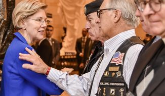 Sen. Elizabeth Warren, Massachusetts Democrat, who was instrumental in placing the POW/MIA Chair of Honor in the U.S. Capitol in November, greets Rolling Thunder, Inc. Founder and Executive Director Artie Muller (center, in beret) and Legislative Director Gus Dante. (Photo by Patrick J. Hughes, Rolling Thunder Inc. National Photographer www.patrickjhughes.org.)