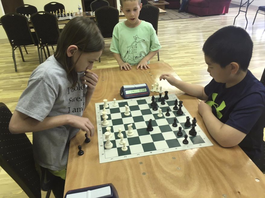 In this May 2018 photo Ben Lauer, left, of Mount Laurel, and Maxwell Wang, of Cherry Hill, play chess at the South Jersey Innovation Center in Marlton, N.J. (Celeste E. Whittaker/Camden Courier-Post via AP)