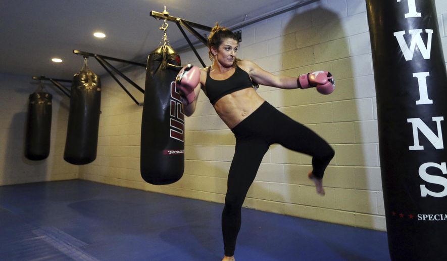 In this May 7, 2018 photo, Lizabeth Loud, 32, works out at the FAF Gym in Holbrook, Mass. Loud says her month, when forced into treatment for her heroin and prescription painkiller addiction, was the start of a personal turnaround. She's been sober about a year and a half. But critics, including many doctors, law enforcement officials and civil rights advocates, caution that success stories like Loud's are an exception. Research suggests involuntary commitment largely doesn't work and could raise the danger of overdose for those who relapse after treatment. (AP Photo/Elise Amendola)