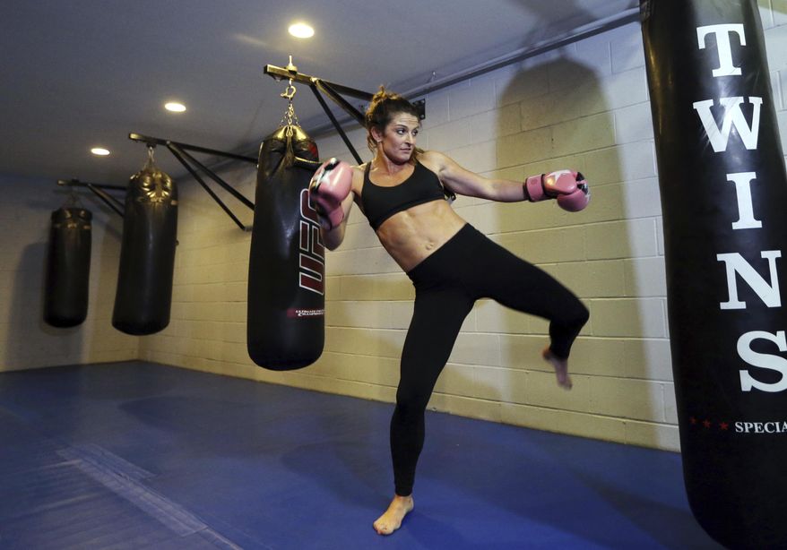 In this May 7, 2018 photo, Lizabeth Loud, 32, works out at the FAF Gym in Holbrook, Mass. Loud says her month, when forced into treatment for her heroin and prescription painkiller addiction, was the start of a personal turnaround. She's been sober about a year and a half. But critics, including many doctors, law enforcement officials and civil rights advocates, caution that success stories like Loud's are an exception. Research suggests involuntary commitment largely doesn't work and could raise the danger of overdose for those who relapse after treatment. (AP Photo/Elise Amendola)