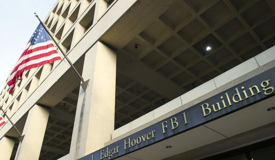 In this Nov. 2, 2016, file photo, the FBI&#39;s J. Edgar Hoover headquarters building in Washington. (AP Photo/Cliff Owen, File)