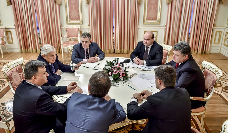 George Soros, second left, chairman of Soros Fund Management and founder of The Open Society Institute, speak with Ukrainian President Petro Poroshenko, right, in Kiev, Ukraine, Tuesday, Jan. 13, 2015. (AP Photo/Mykola Lazarenko, Pool) **FILE**

