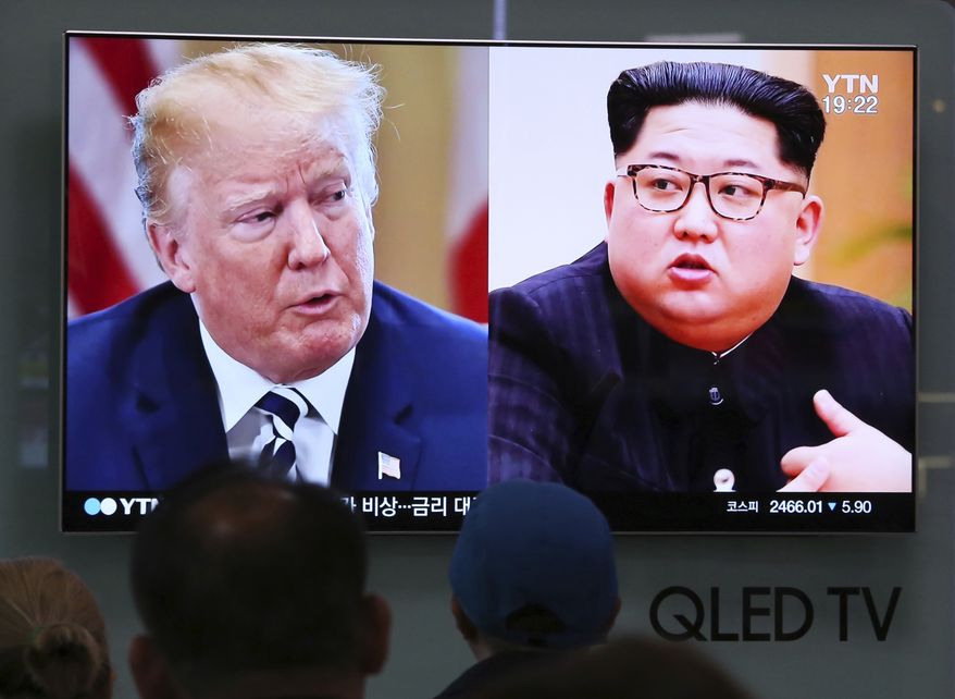 People watch a TV screen showing file footage of U.S. President Donald Trump, left, and North Korean leader Kim Jong Un during a news program at the Seoul Railway Station in Seoul, South Korea, Thursday, May 24, 2018. North Korea carried out what it said is the demolition of its nuclear test site Thursday, setting off a series of explosions over several hours in the presence of foreign journalists. (AP Photo/Ahn Young-joon)