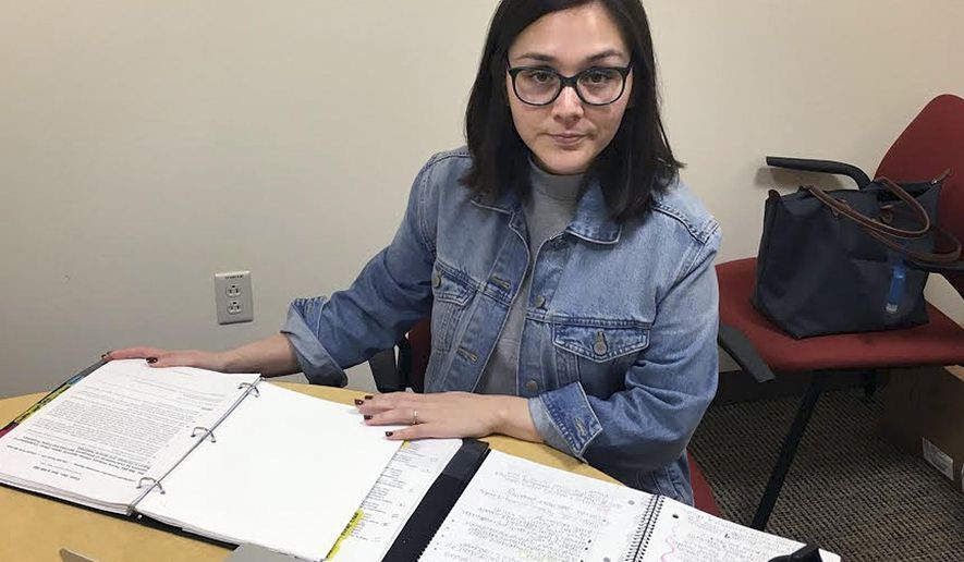 In this May 3, 2018 photo, Denia Perez, a student at Quinnipiac University School of Law, poses for a photo on the school's North Haven, Conn., campus. Connecticut's Judicial Branch is in the process of changing its rules to allow law students who don't have legal residency in the U.S to become practicing lawyers in the state. Perez, who was brought illegally to the United States from Mexico when she was 11 months old and who graduated this month, proposed the change. (Lauren Takores/Record-Journal via AP)