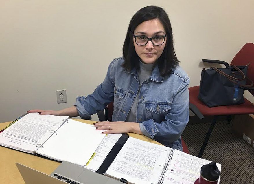 In this May 3, 2018 photo, Denia Perez, a student at Quinnipiac University School of Law, poses for a photo on the school's North Haven, Conn., campus. Connecticut's Judicial Branch is in the process of changing its rules to allow law students who don't have legal residency in the U.S to become practicing lawyers in the state. Perez, who was brought illegally to the United States from Mexico when she was 11 months old and who graduated this month, proposed the change. (Lauren Takores/Record-Journal via AP)