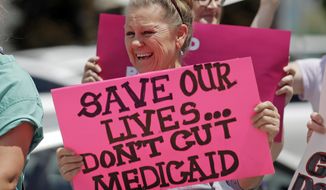 In this June 27, 2017, file photo, protesters block a street during a demonstration against the Republican bill in the U.S. Senate to replace former President Barack Obama&#39;s health care law, in Salt Lake City. Utah lawmakers are expressing concern about the possibility that voters could expand Medicaid after years of debate at the legislature. (AP Photo/Rick Bowmer, File)