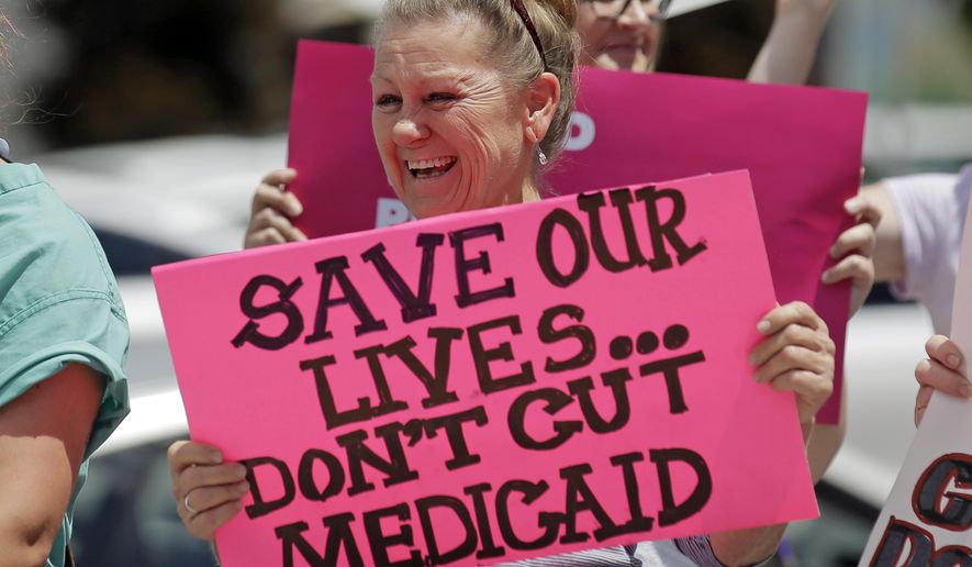 In this June 27, 2017, file photo, protesters block a street during a demonstration against the Republican bill in the U.S. Senate to replace former President Barack Obama&#39;s health care law, in Salt Lake City. Utah lawmakers are expressing concern about the possibility that voters could expand Medicaid after years of debate at the legislature. (AP Photo/Rick Bowmer, File)