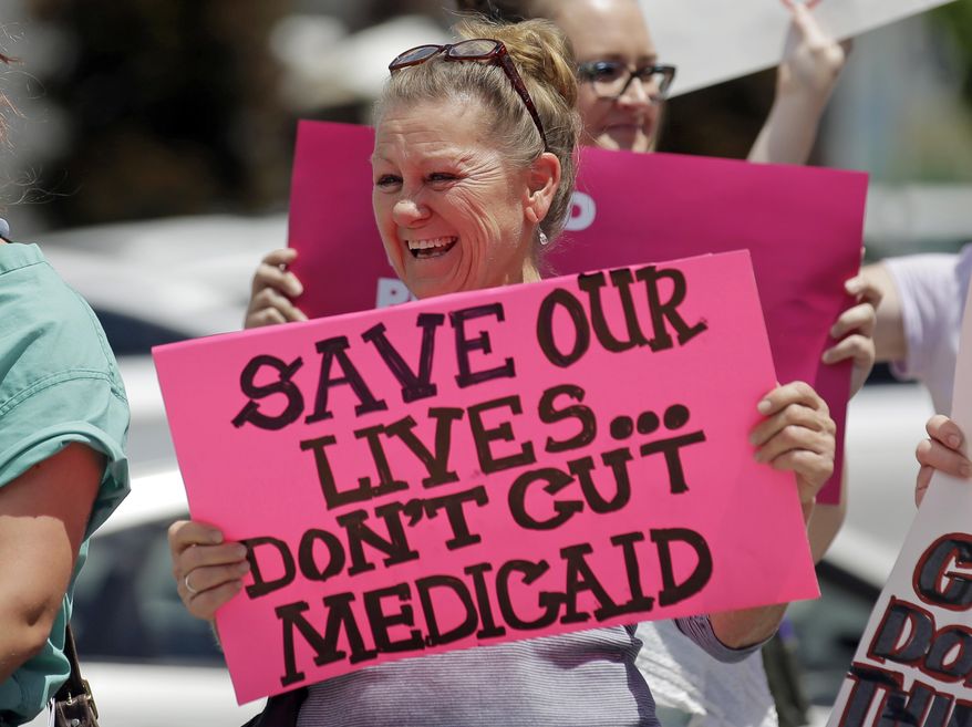 In this June 27, 2017, file photo, protesters block a street during a demonstration against the Republican bill in the U.S. Senate to replace former President Barack Obama's health care law, in Salt Lake City. Utah lawmakers are expressing concern about the possibility that voters could expand Medicaid after years of debate at the legislature. (AP Photo/Rick Bowmer, File)