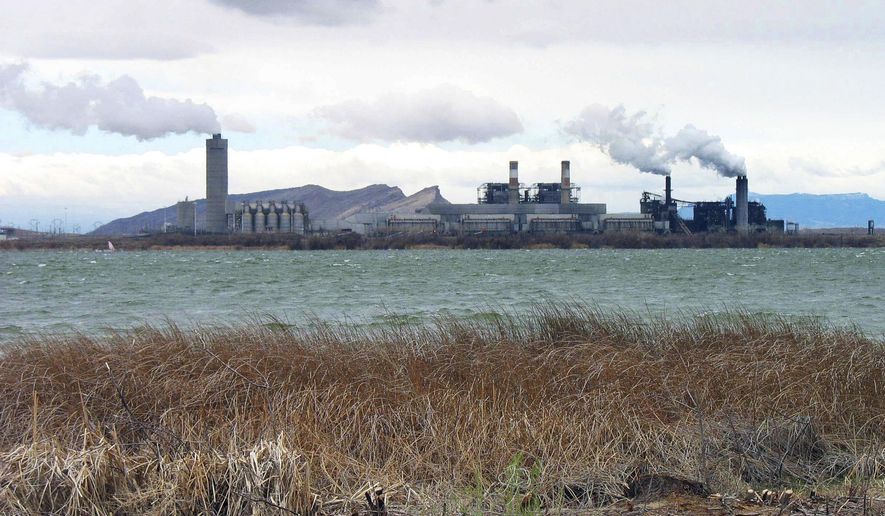 FILE - This April, 2006 file photo shows the Four Corners Power Plant in Waterflow, N.M., near the San Juan River in northwestern New Mexico. Federal regulators are being targeted by a coalition of environmental groups who say a coal-fired power plant that provides electricity to Arizona customers has been operating under a water permit that should have been updated more than a decade ago. The groups are concerned that any failure to meet modern pollution control requirements could affect the Navajo Nation and other areas downstream from the Four Corners Power Plant. (AP Photo/Susan Montoya Bryan, File)
