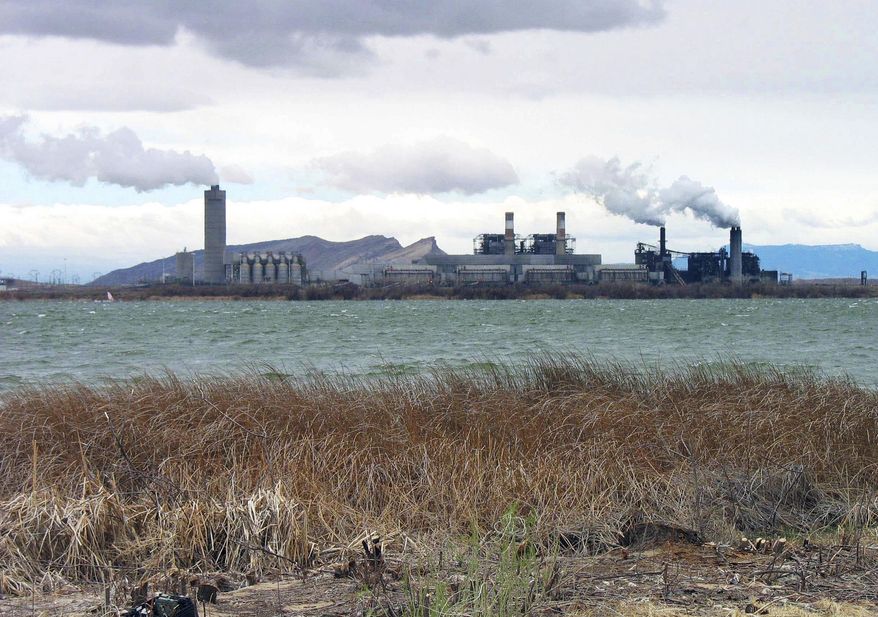FILE - This April, 2006 file photo shows the Four Corners Power Plant in Waterflow, N.M., near the San Juan River in northwestern New Mexico. Federal regulators are being targeted by a coalition of environmental groups who say a coal-fired power plant that provides electricity to Arizona customers has been operating under a water permit that should have been updated more than a decade ago. The groups are concerned that any failure to meet modern pollution control requirements could affect the Navajo Nation and other areas downstream from the Four Corners Power Plant. (AP Photo/Susan Montoya Bryan, File)