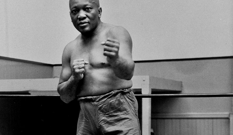 FILE - In this 1932 file photo, boxer Jack Johnson, the first black world heavyweight champion, poses in New York City. President Donald Trump on Thursday, May 24, 2018, granted a rare posthumous pardon to boxing&#x27;s first black heavyweight champion, clearing Jack Johnson’s name more than 100 years after a racially-charged conviction.   (AP Photo/File)