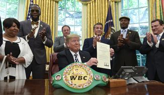 President Donald Trump center, posthumous pardons Jack Johnson, boxing&#x27;s first black heavyweight champion, during an event in the Oval Office of the White House in Washington, Thursday, May 24, 2018. Trump is joined by, from left, Linda Haywood, who is Johnson&#x27;s great-great niece, heavyweight champion Deontay Wilder, Keith Frankel, Sylvester Stallone, former heavyweight champion Lennox Lewis, and World Boxing Council President Mauricio Sulaiman Saldivar. (AP Photo/Susan Walsh)