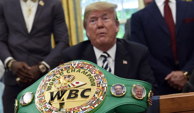 A boxing belt presented to President Donald Trump, sits on the desk in the Oval Office of the White House in Washington, Thursday, May 24, 2018, where Trump granted a posthumous pardon to Jack Johnson, boxing&#x27;s first black heavyweight champion. (AP Photo/Susan Walsh) ** FILE **