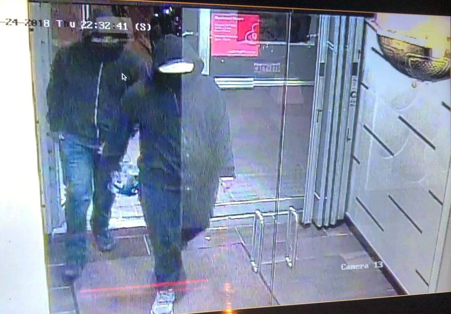 In this image made from CCTV footage released by Peel Regional Police, two suspects enter a glass doorway of the Bombay Bhel Indian restaurant, late Thursday, May 24, 2018, in Mississauga, suburb of Toronto, Canada. Police are searching for the two suspects in connection with the explosion caused by &quot;improvised explosive device&quot; ripped through the restaurant, wounding 15 people, Canadian police said. (Peel Regional Police via AP)