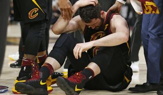 Cleveland Cavaliers&#39; Kevin Love sits on the court while holding his head during the first half of Game 6 of the team&#39;s NBA basketball Eastern Conference finals against the Boston Celtics, Friday, May 25, 2018, in Cleveland. (AP Photo/Ron Schwane)