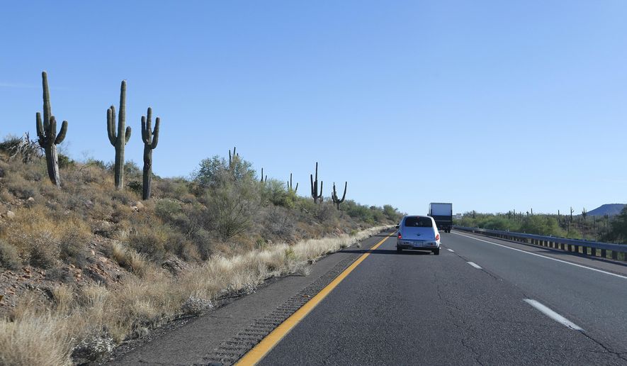 In this June 21, 2013, photo, traffic moves past several saguaro cactuses along the northbound lanes of the Interstate 17 in New River, Ariz. The Arizona Department of Transportation is planning two new &amp;quot;flex&amp;quot; lanes to ease congestion on Interstate 17. The Arizona Republic reports the lanes will carry people north Fridays and Saturdays, and south on Sundays. But construction won’t begin until 2021 and will take about two years to complete. (AP Photo/Ross D. Franklin)