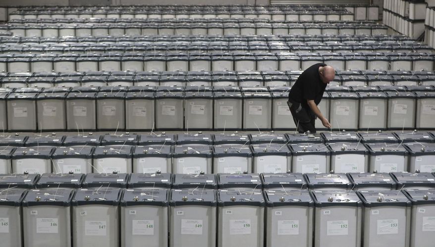 Election warehouse manager Michael Leonard checks the seals on the ballot boxes in Dublin, Thursday May 24, 2018, ready to be delivered to polling stations for Friday's referendum on the 8th Amendment of the Irish Constitution. (Niall Carson/PA via AP)