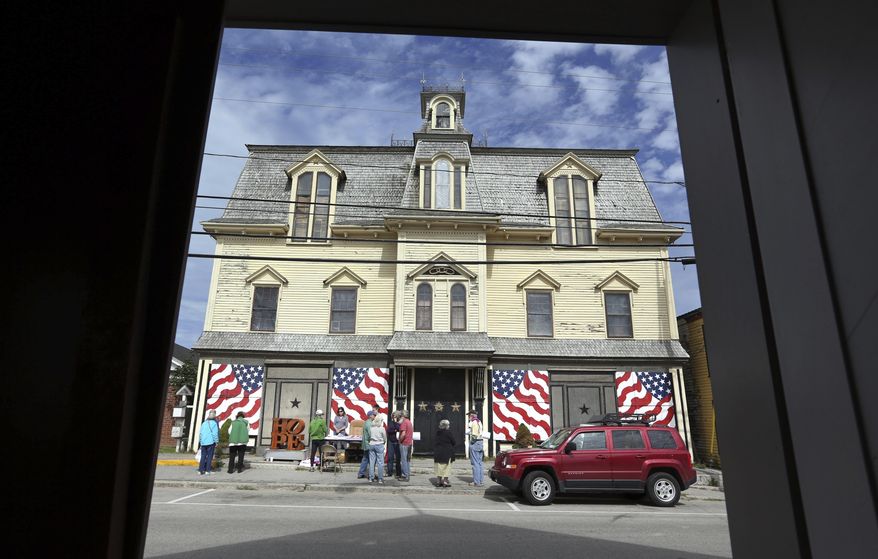 FILE - In this Sept. 13, 2014, file photo, fans gather outside "Star of Hope" the residence of artist Robert Indiana on Vinalhaven Island, Maine. Indiana died on May 19, 2018. His will calls for his home and studio to be transformed into a museum and for his collection to be preserved and open to the public. (AP Photo/Robert F. Bukaty, File)