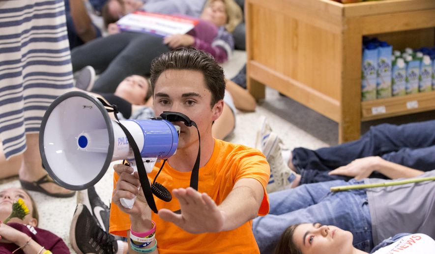 Marjorie Stoneman Douglas High School student David Hogg speaks as demonstrators lie on the floor at a Publix Supermarket in Coral Springs, Fla., Friday, May 25, 2018. Students from the Florida high school where 17 people were shot and killed earlier this year did a &amp;quot;die in&amp;quot; protest at a supermarket chain that backs a gubernatorial candidate allied with the National Rifle Association. Shortly before the &amp;quot;die-in&amp;quot; Publix announced that it will suspend political donations. (AP Photo/Wilfredo Lee) ** FILE **