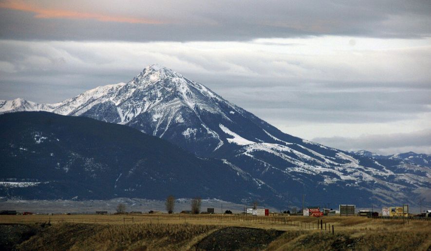 FILE - This Nov. 21, 2016 file photo shows Emigrant Peak towering over the Paradise Valley in Montana north of Yellowstone National Park. A gold exploration proposal in the area has suffered a significant setback after a judge ruled Montana officials understated mining's potential harm to land, water and wildlife. (AP Photo/Matthew Brown, File)