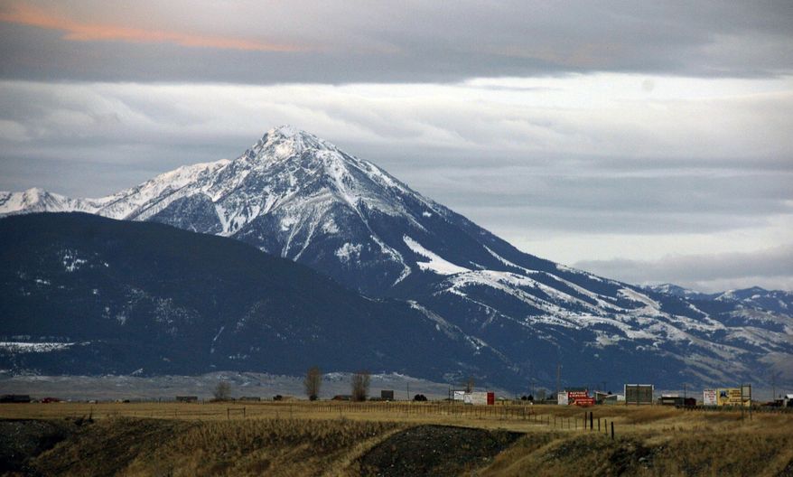 FILE - This Nov. 21, 2016 file photo shows Emigrant Peak towering over the Paradise Valley in Montana north of Yellowstone National Park. A gold exploration proposal in the area has suffered a significant setback after a judge ruled Montana officials understated mining's potential harm to land, water and wildlife. (AP Photo/Matthew Brown, File)