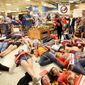 Demonstrators lie on the floor at a Publix Supermarket in Coral Springs, Florida, on Friday. Students from the Florida high school where 17 people were killed did a &quot;die in&quot; protest at the supermarket chain. (Associated Press)