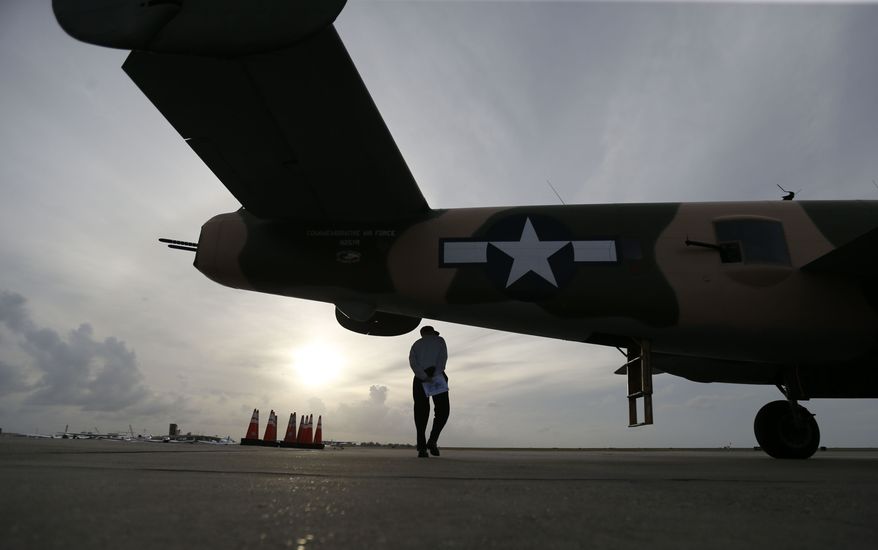 World War II veteran Mike Fedirko, 91, walks underneath the B-25 Mitchell bomber &quot;Yellow Rose&quot; after he flew aboard the plane at New Orleans Lakefront Airport in New Orleans, Thursday, Oct. 22, 2015. Fedirko flew missions in a B-25 during the war. The planes, part of the Commemorative Air Force, are in town for the WWII AirPower Expo 2015, hosted by the National World War II Museum, which runs through the weekend. (AP Photo/Gerald Herbert)
