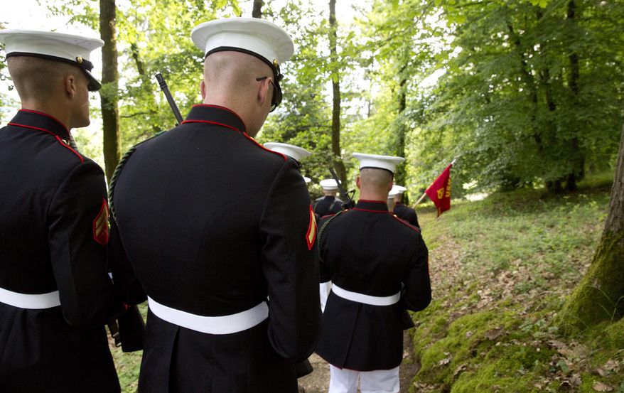 U.S. Marines walk through the battlefield of Belleau Wood prior to a Memorial Day commemoration at the Aisne-Marne American Cemetery in Belleau, France, Sunday, May 27, 2018. The cemetery contains more that 2,000 American dead. (AP Photo/Virginia Mayo) ** FILE **