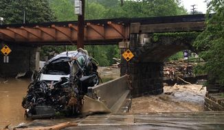 A damaged vehicle swept away by floodwaters stops by a utility pole in Ellicott City, Md., Sunday, May 27, 2018. Roaring flash floods struck the Maryland city Sunday that had been wracked by similar devastation two years ago, its main street turned into a raging river that reached the first floor of some buildings and swept away parked cars, authorities and witnesses say. (Libby Solomon/The Baltimore Sun via AP)