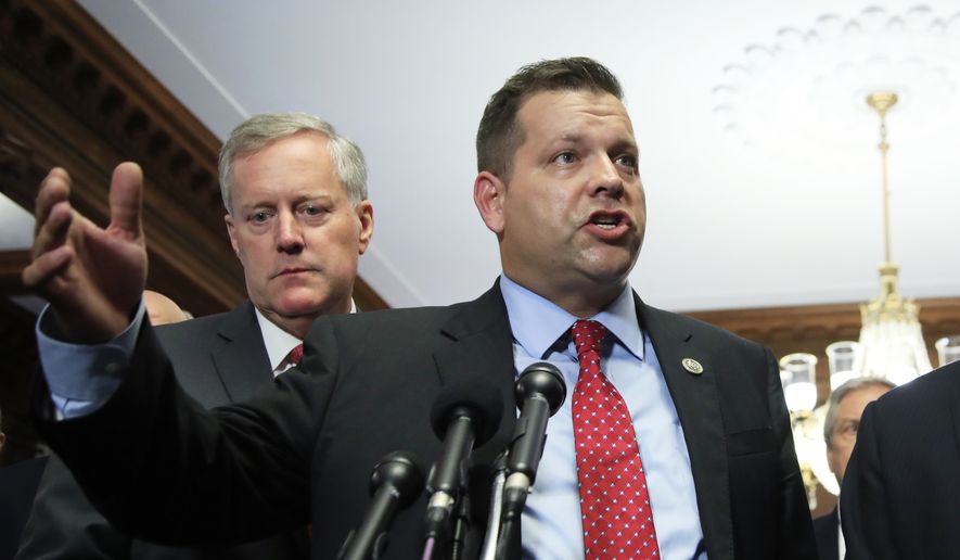 Freedom Caucus member Rep. Thomas Garrett, R-Va., with Chairman Rep. Mark Meadows, R-S.C., speaks to reporters during a news conference on Capitol Hill in Washington, Wednesday, July 19, 2017, calling on the House to vote on clean repeal of the Affordable Care Act. (AP Photo/Manuel Balce Ceneta) ** FILE **